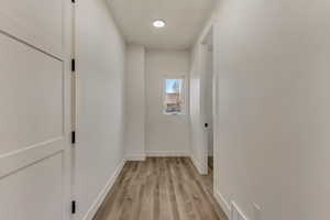 Hall featuring light hardwood / wood-style flooring