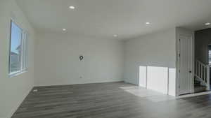 Unfurnished room with dark wood-type flooring