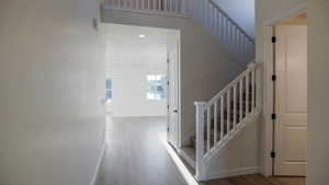 Staircase featuring hardwood / wood-style flooring