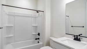 Full bathroom featuring vanity, shower / bathtub combination, and toilet