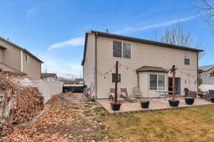 Rear view of property featuring a patio and a lawn