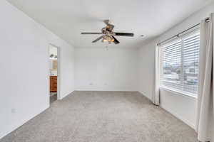 Huge primary suite with ceiling fan, newer carpet and great views