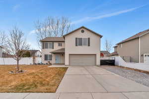 Front facade featuring a garage and a front lawn.  Large RV parking area.