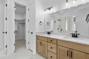 Bathroom with vanity and a shower with shower door