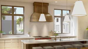 Kitchen with plenty of natural light, sink, a breakfast bar area, and decorative light fixtures