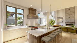 Kitchen featuring sink, double oven range, custom range hood, pendant lighting, and light hardwood / wood-style floors