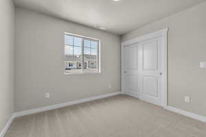 Unfurnished bedroom featuring carpet flooring