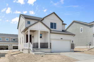 View of front facade featuring a garage and covered porch