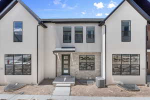 View of front of property featuring central AC unit