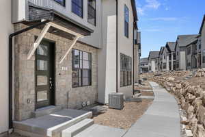 View of exterior entry featuring central AC unit