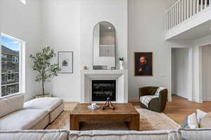 Living room featuring hardwood / wood-style floors and a high ceiling