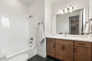 Full bathroom with tile patterned floors, toilet, shower / bathing tub combination, and vanity