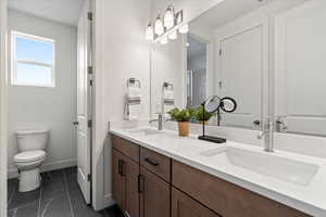 Bathroom with vanity, tile patterned flooring, toilet, and walk in shower