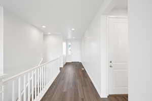 Corridor featuring dark hardwood / wood-style flooring