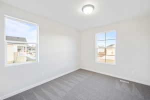 Carpeted empty room featuring plenty of natural light