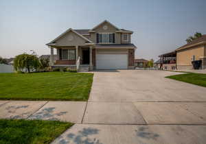 View of front of property with a garage and a front yard