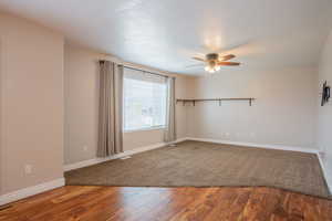 Unfurnished room featuring wood-type flooring and ceiling fan