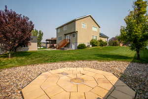 Rear view of property featuring a patio area and a lawn