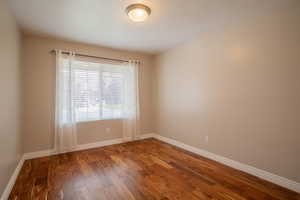 Unfurnished room featuring hardwood / wood-style flooring