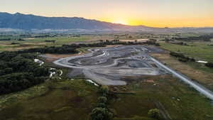 Aerial view at dusk featuring a mountain view and a rural view