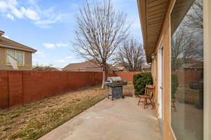 View of patio with a grill