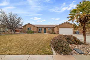 Ranch-style home with a garage and a front lawn