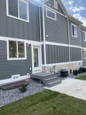 Back of property featuring cooling unit and a patio area