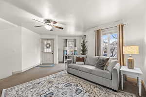 Living room with carpet and ceiling fan