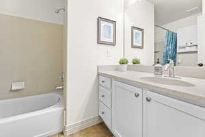 Bathroom featuring vanity, and shower / bath combo with shower curtain