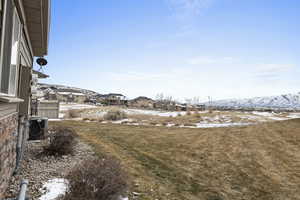 Snowy yard featuring a mountain view