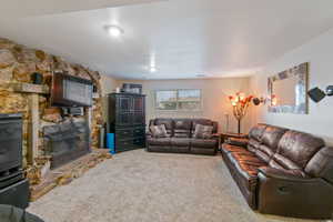 Carpeted living room with a fireplace