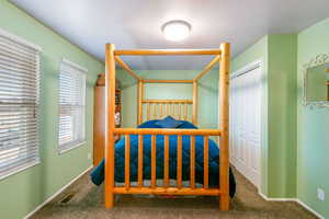 Bedroom featuring a closet and carpet flooring