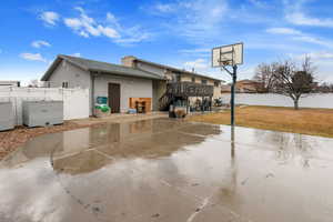 View of basketball court featuring a lawn