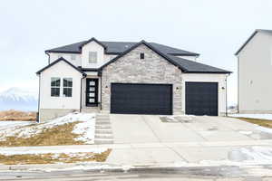 View of front of property featuring a garage and a mountain view