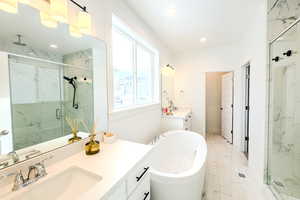 Bathroom with vanity and plus walk in shower