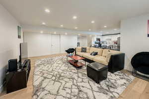 Living room with light hardwood / wood-style flooring