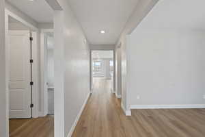 Hall with light hardwood / wood-style flooring