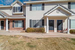 Townhome / multi-family property with a front lawn