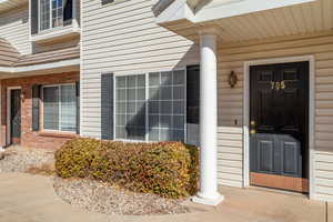 View of exterior entry featuring a porch