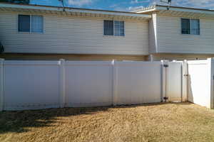 Back of house with a lawn