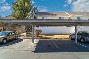 View of vehicle parking featuring a carport