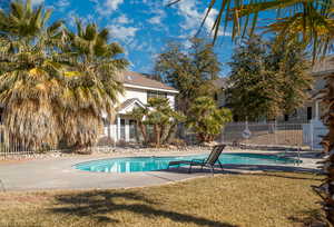 View of swimming pool with a yard and a patio area