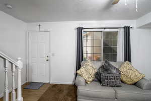 Foyer entrance featuring hardwood / wood-style floors, a textured ceiling, and ceiling fan