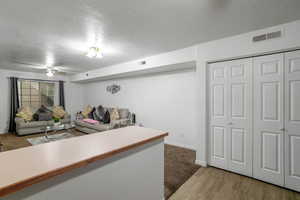 Living room featuring hardwood / wood-style floors and a textured ceiling