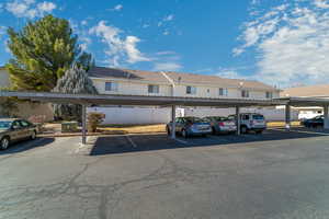 View of parking / parking lot with a carport