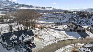 Snowy aerial view featuring a mountain view