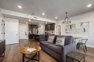 Living room featuring sink and light hardwood / wood-style floors