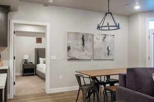 Dining room with an inviting chandelier and hardwood / wood-style floors