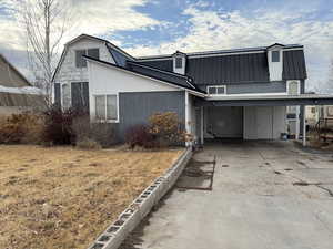 View of front of property with a carport