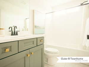 Full bathroom with shower / bathtub combination with curtain, vanity, and toilet